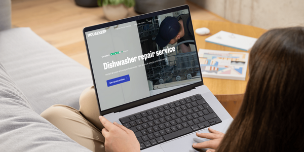 Women booking a dishwasher repair through the Housekeep website