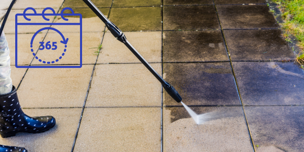 Gardener power washing patio