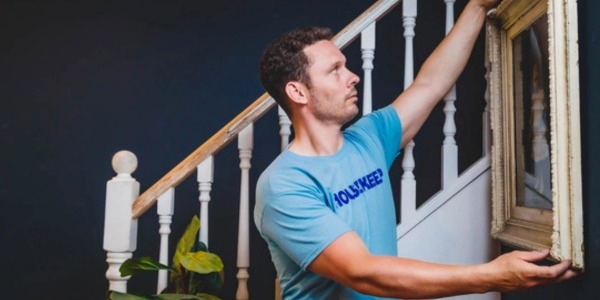 Handyman hanging a picture frame