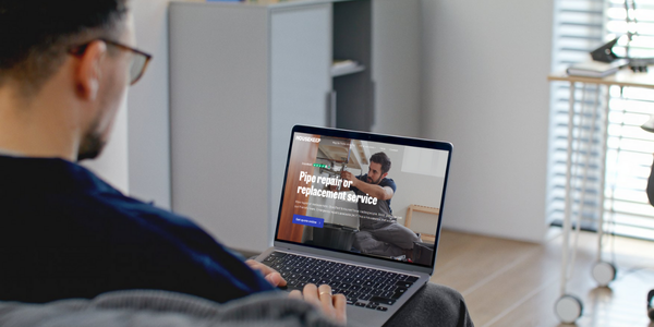 Man booking a plumber to fix a leaking pipe on the Housekeep website