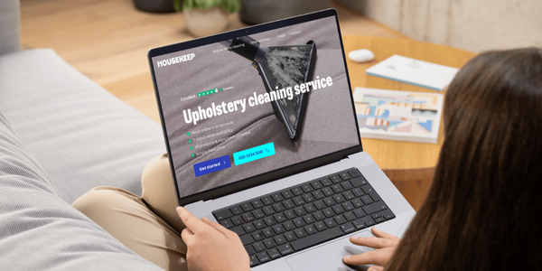 Women booking a sofa clean through the Housekeep website