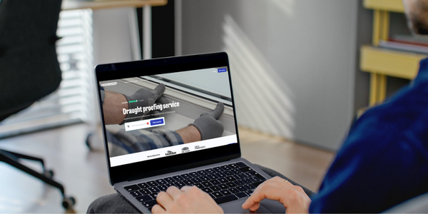 Man booking a draught proofing service through the Housekeep website on their laptop