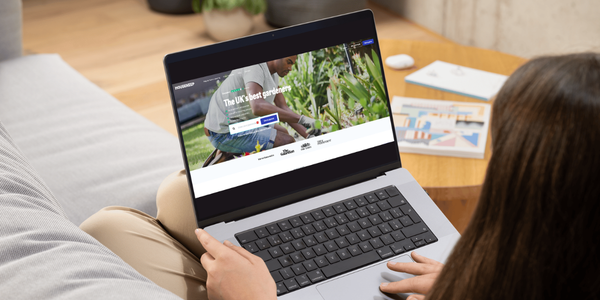 A person booking lawn irrigation installation on the Housekeep website on their laptop